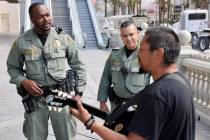 Metropolitan Police Department’s Homeless Outreach Team officers Dwayne Henderson, left, ...