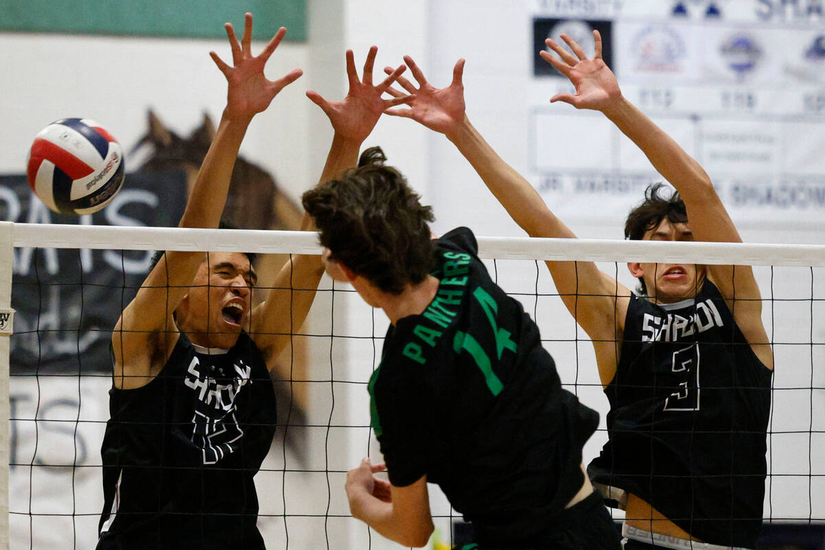 Shadow Ridge's Kingston Jerome (12) and Shadow Ridge's Caleb Fisher (3) try to block a spike by ...