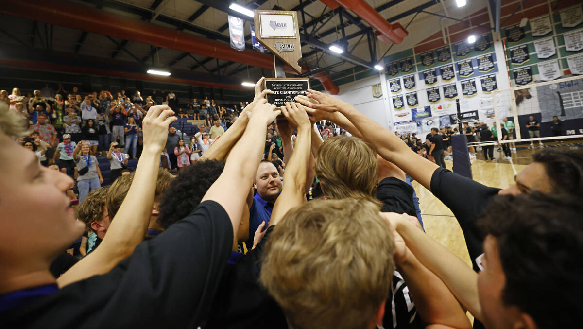 Shadow Ridge’s players hold up the trophy to celebrate their victory against Palo Verde ...