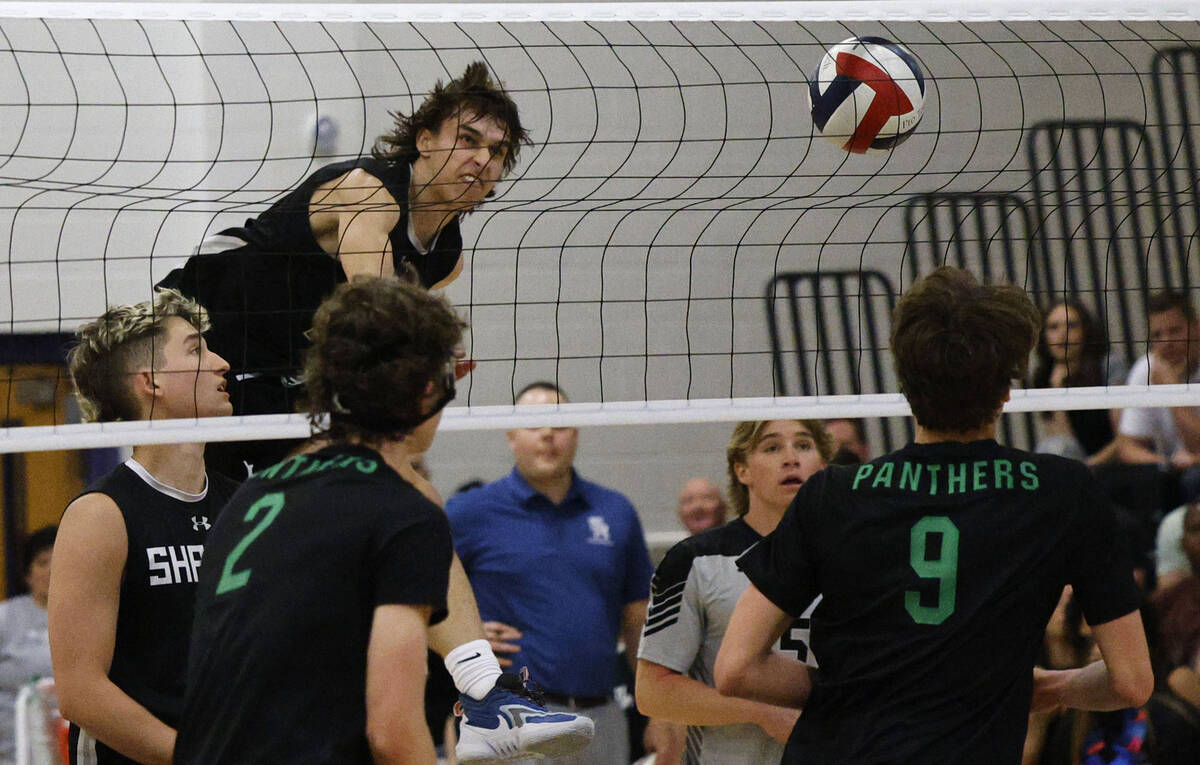 Shadow Ridge's Brady Beko (14) spikes the ball against Palo Verde's Colton Mendez (2) and Palo ...