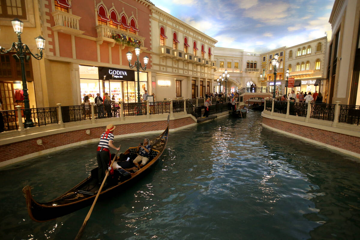 Gondolas float through the Grand Canal Shoppes at The Venetian on the Strip in Las Vegas Thursd ...