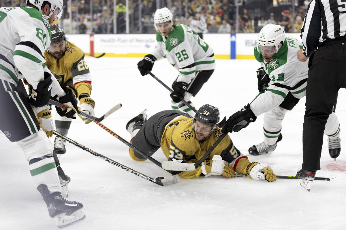 Golden Knights center Teddy Blueger (53) is caught in a puck battle between Knights left wing W ...