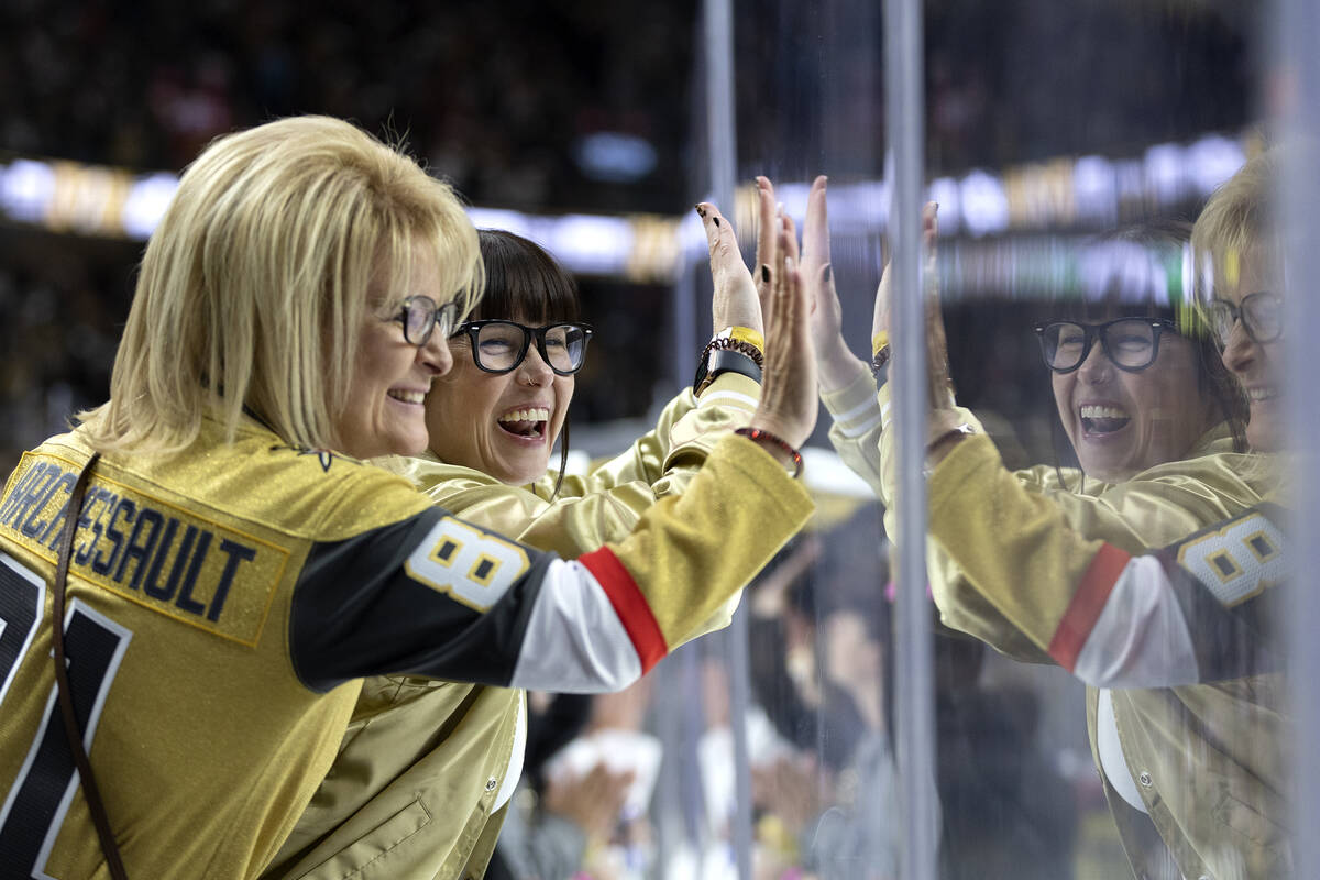 Golden Knights fans smack the boards during the third period in Game 1 of a NHL hockey Western ...