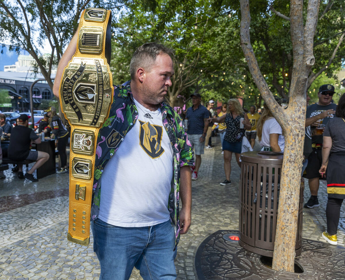 Golden Knights fan Paul Prunier shows off his championship belt outside before the first period ...