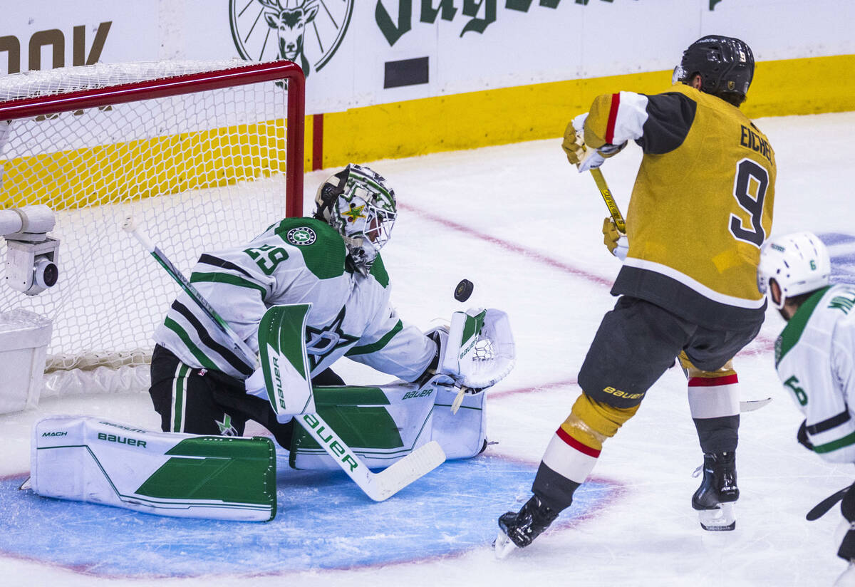 Dallas Stars goaltender Jake Oettinger (29) barely deflects a shot away by Golden Knights cente ...