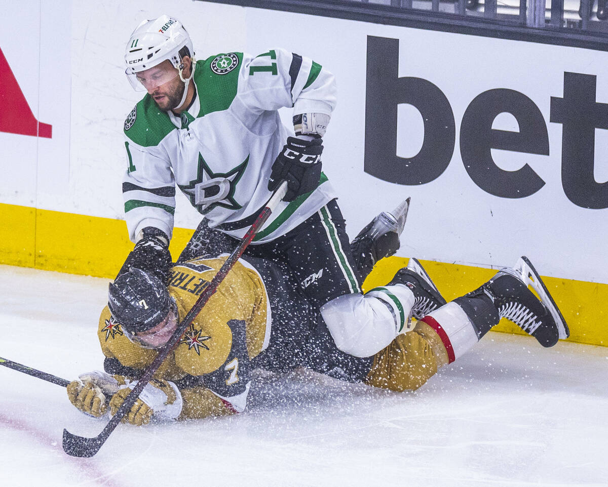 Golden Knights defenseman Alex Pietrangelo (7) catches a face full of ice after being pushed do ...