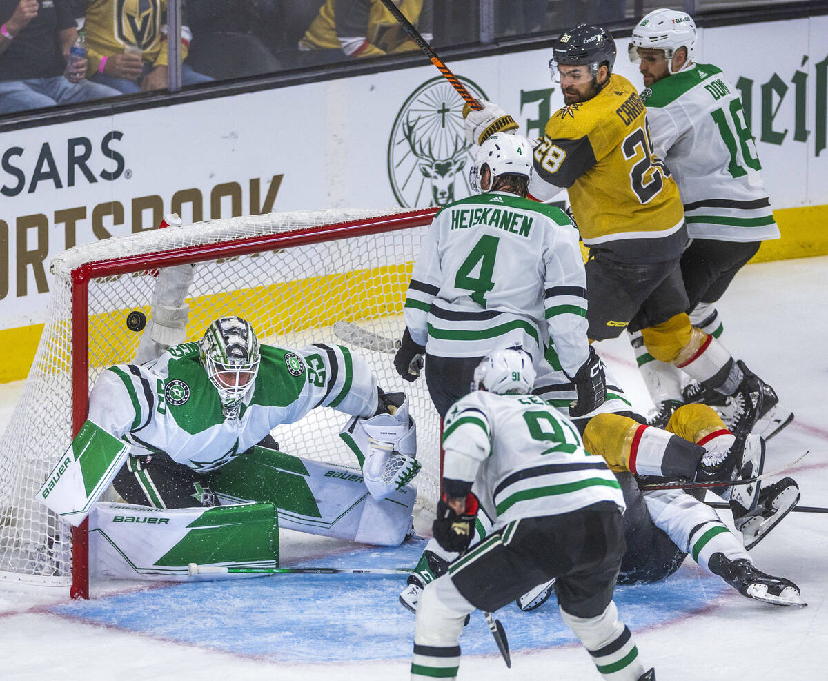 Dallas Stars goaltender Jake Oettinger (29) misses a puck for a score on the deflection after a ...