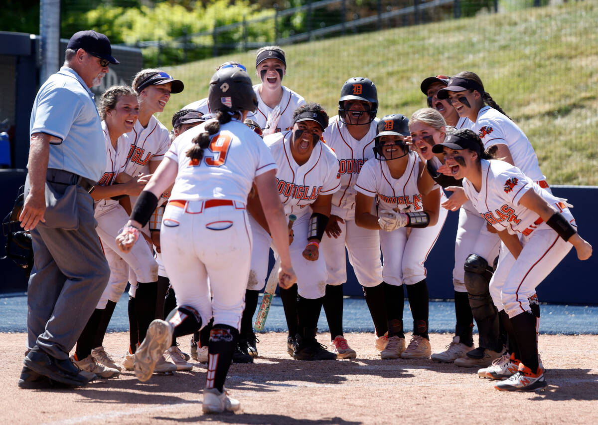 Douglas High's Talia Tretton (19) greeted at home by her teammates after hitting a solo homer a ...