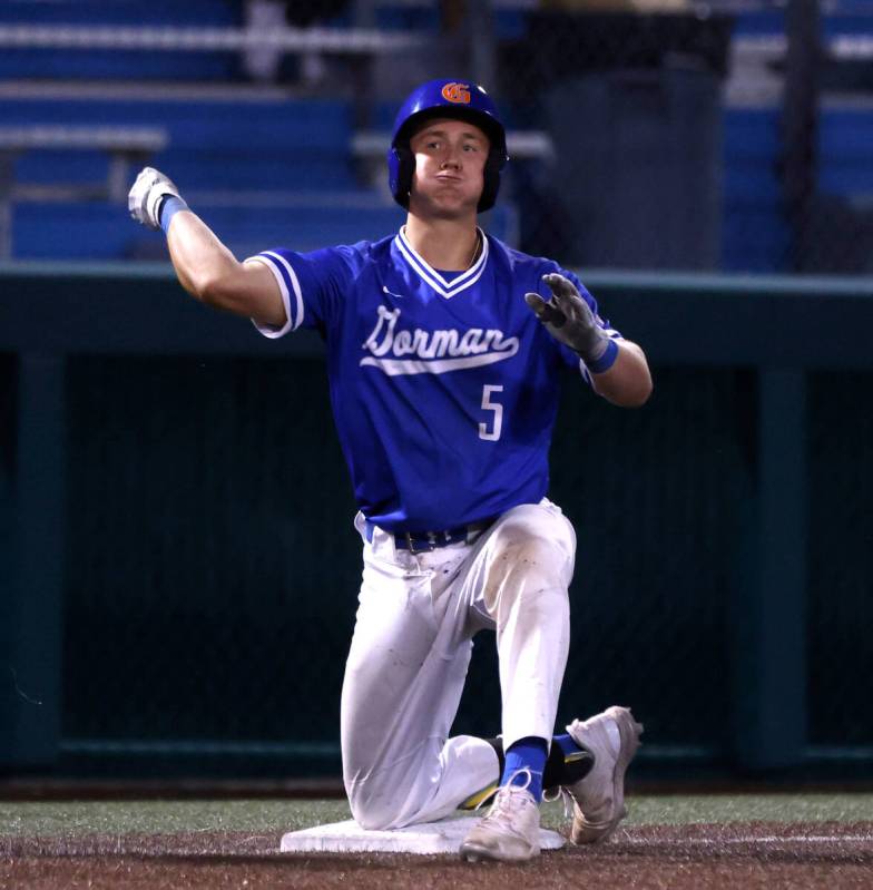 Bishop Gorman High's Burke Mabeus reacts after hitting a triple against Damonte Ranch High duri ...