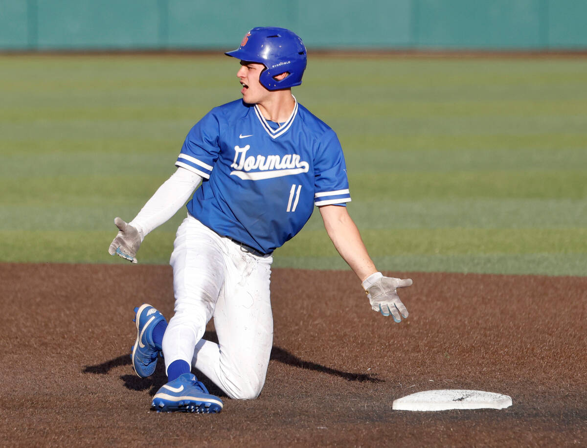 Bishop Gorman High's Billy Scaldeferri protests the call after being tagged out at second by De ...