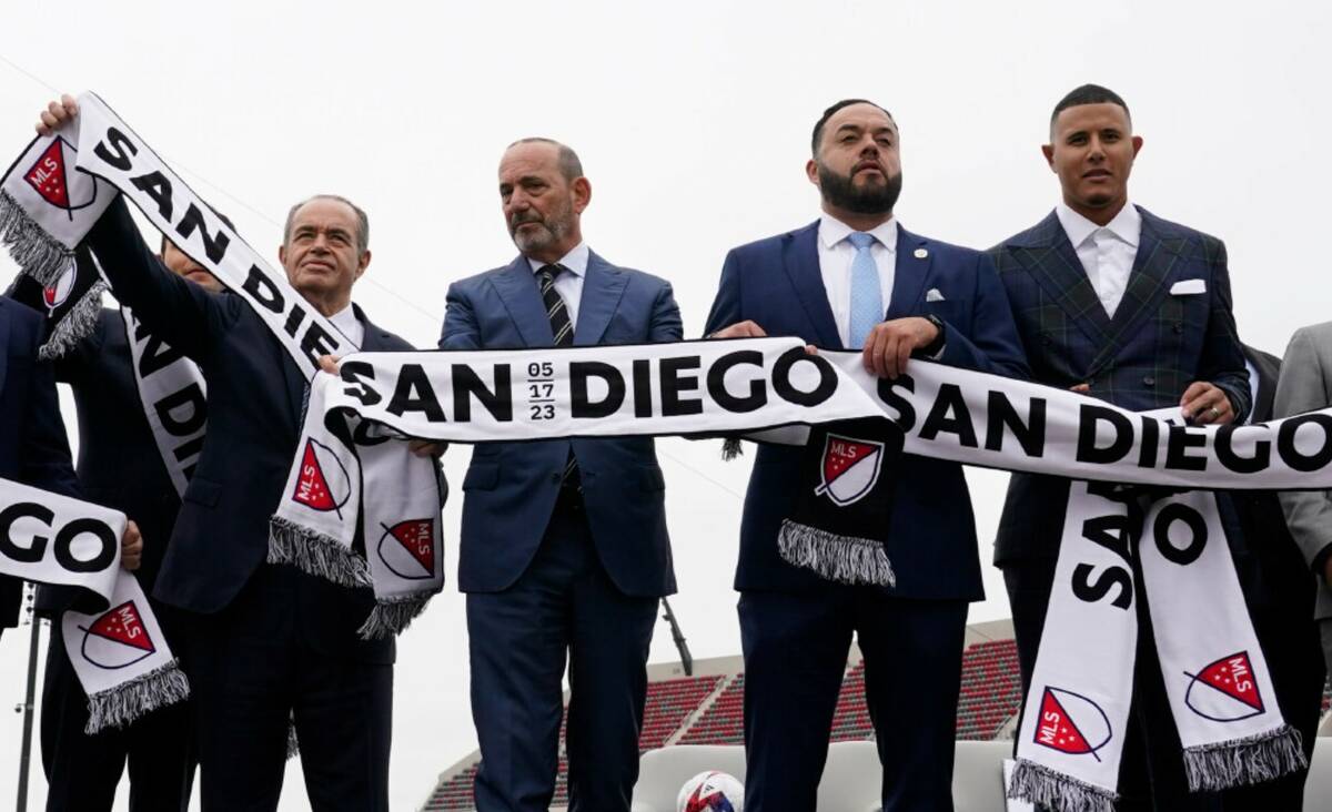 MLS Commissioner Don Garber, second from left, stands with members of the owners group of a new ...