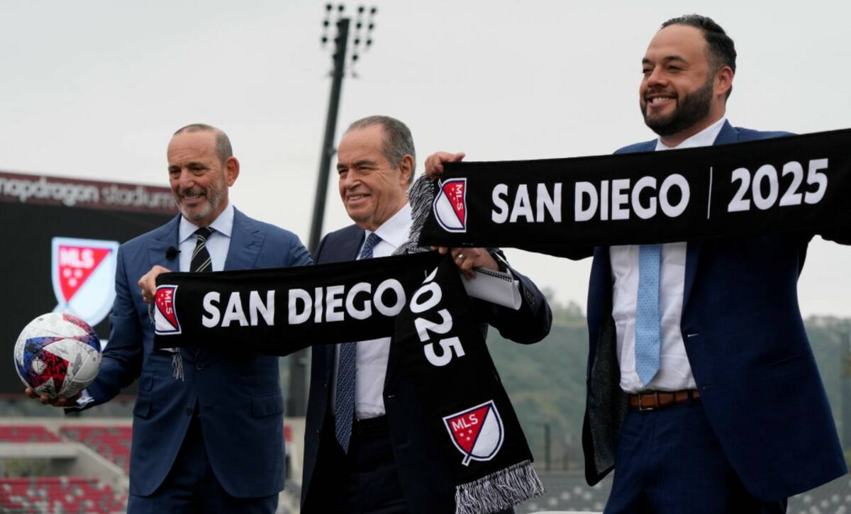 MLS Commissioner Don Garber, left, stands alongside new co-owners Mohamed Mansour, center, and ...