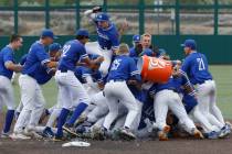 Bishop Gorman players celebrate their win against Desert Oasis after a Class 5A high school bas ...