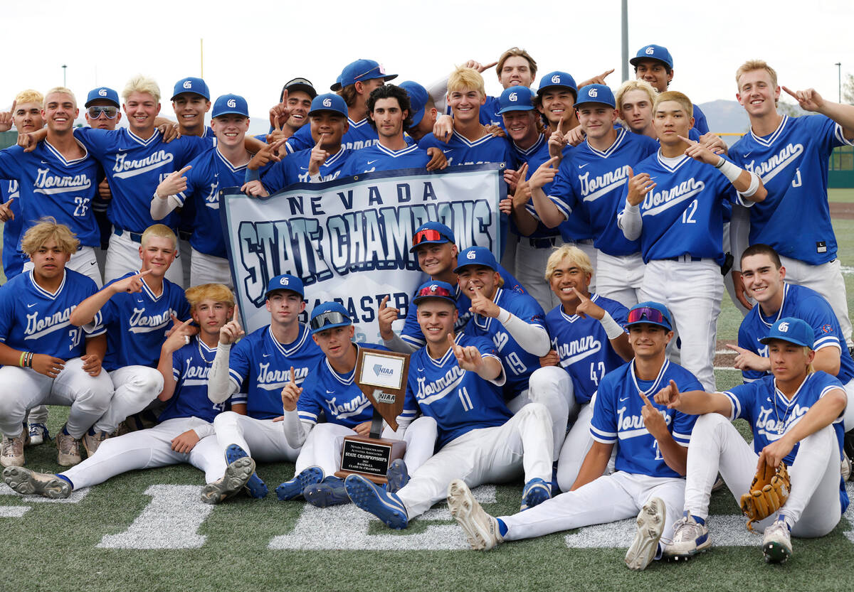 Bishop Gorman players pose for photo with their state title trophy after defeating Desert Oasis ...