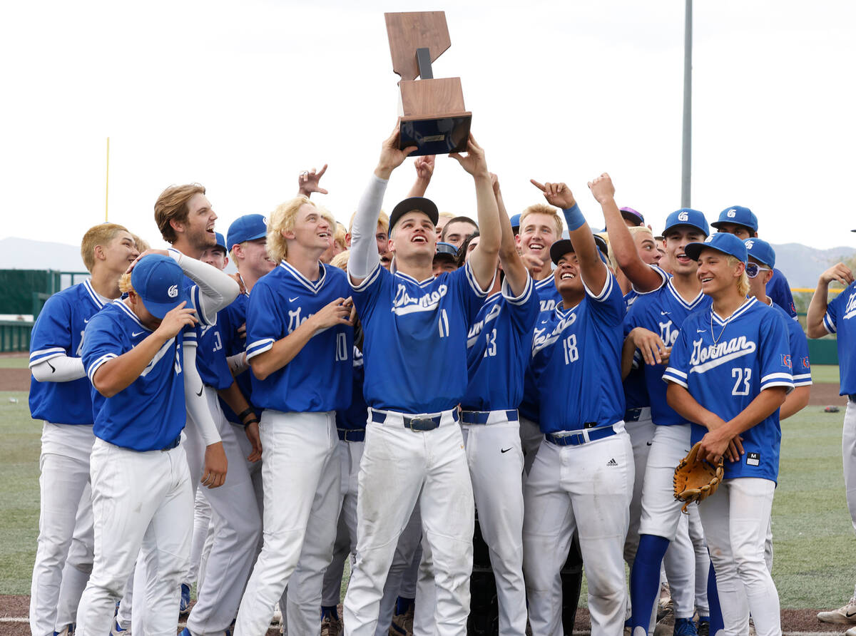 Bishop Gorman players raise their state title trophy after defeating Desert Oasis in a Class 5A ...