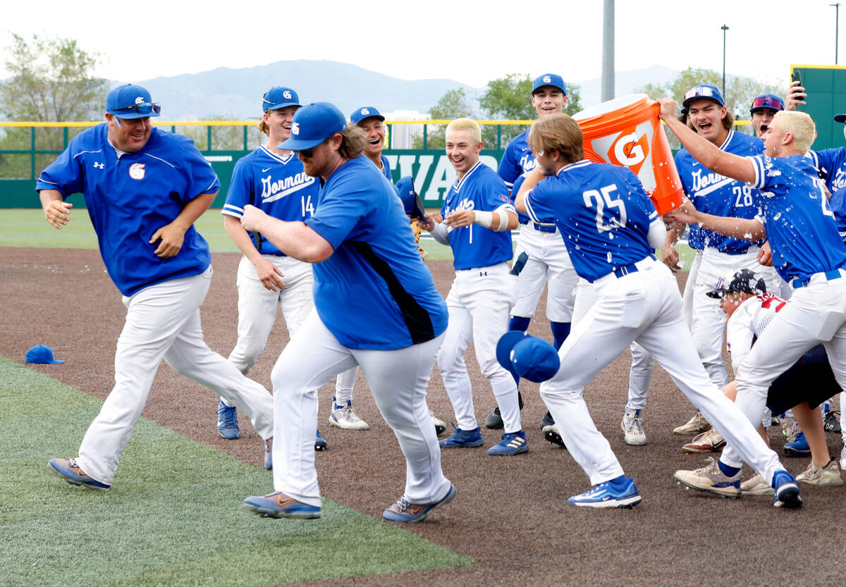 Bishop Gorman players chase their head coach Chris Sheff, left, to give him a Gatorade shower a ...