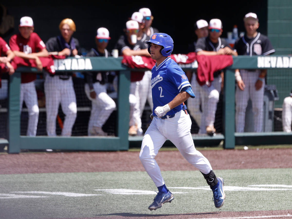Bishop Gorman's Maddox Riske runs the bases after hitting a grand slam as Desert Oasis players ...