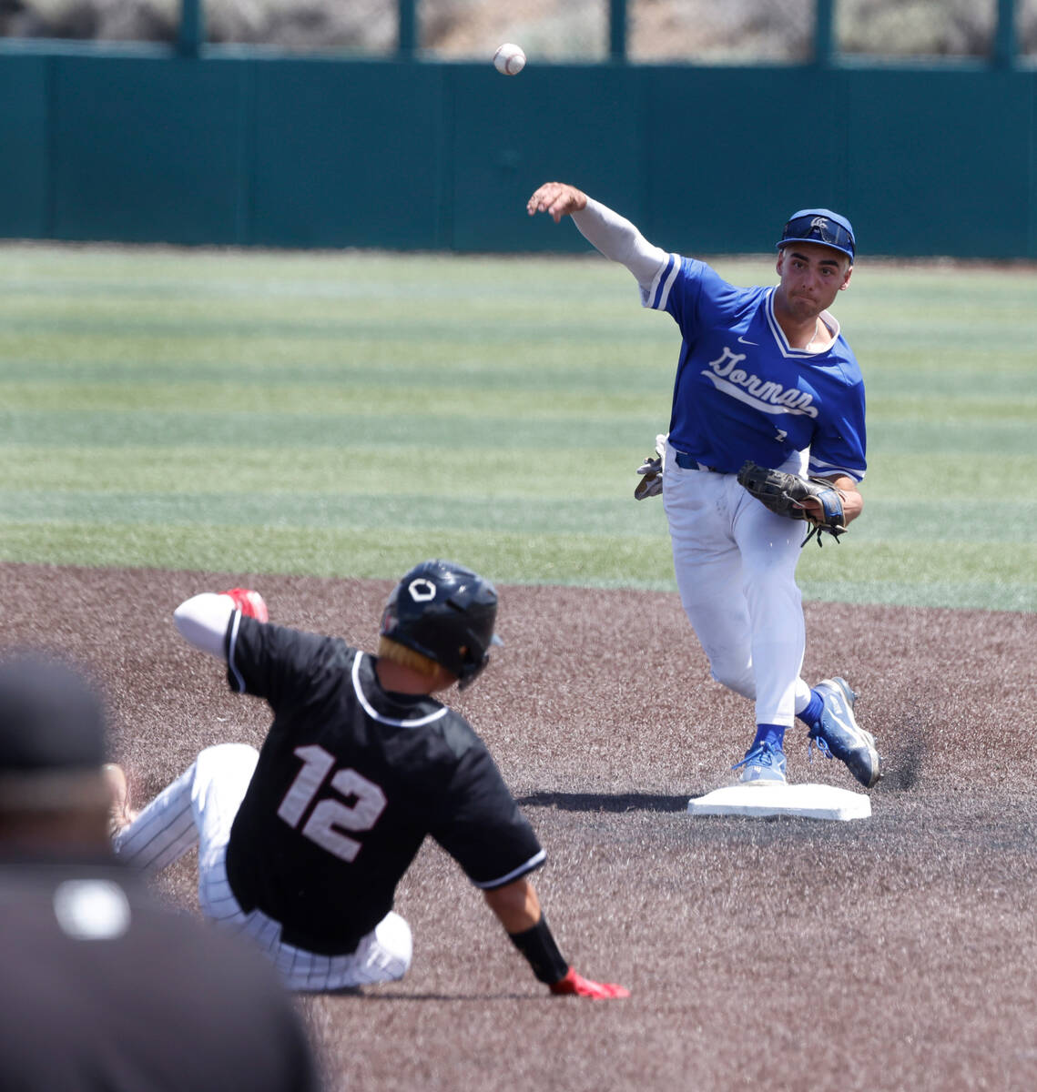 Bishop Gorman's Maddox Riske forces out a sliding Desert Oasis' Seth Lyons (12) and throws for ...