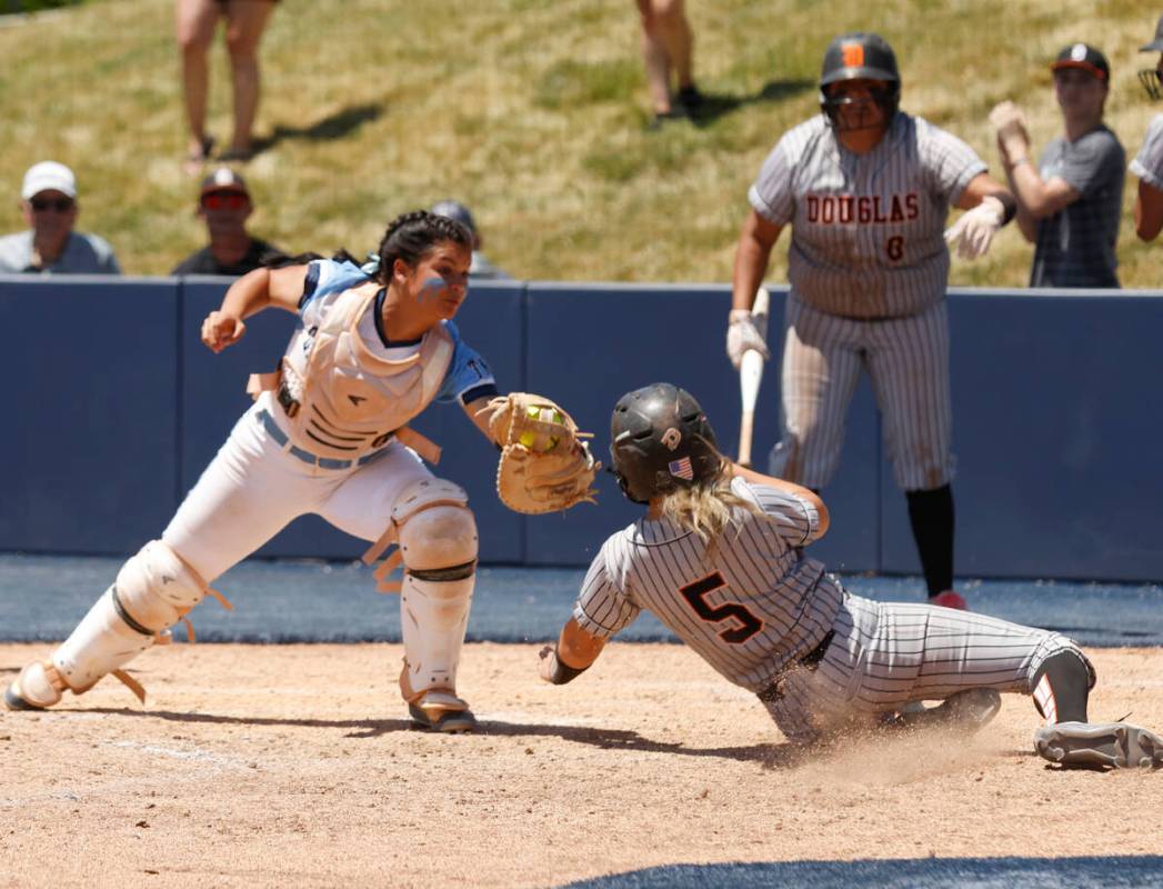 Centennial's Amanda Campos-Colon tags out a sliding Douglas' Ava Delaney (5) at home during a C ...