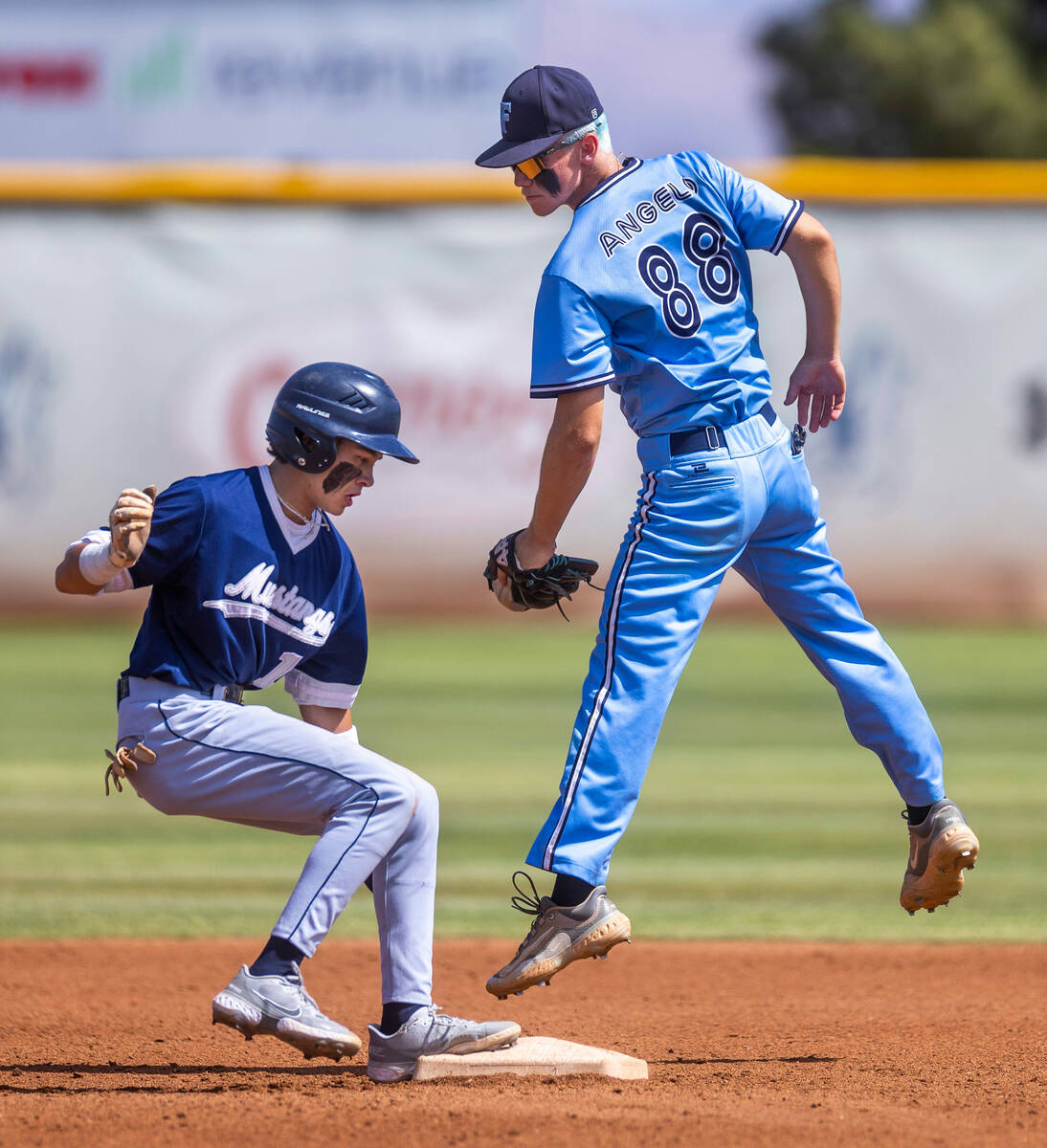 Shadow Ridge runner Michael Brown gets back to the base safely as Foothill SS Landon Angelo com ...