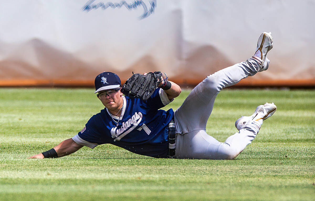 Shadow Ridge OF Evan Harnum makes a sliding catch against Foothill during the third inning of a ...