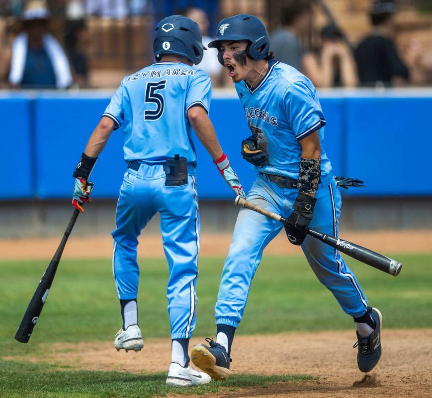 Foothill runner Josh Vaughn is pumped after scoring with teammate batter Matt Szymarek during t ...