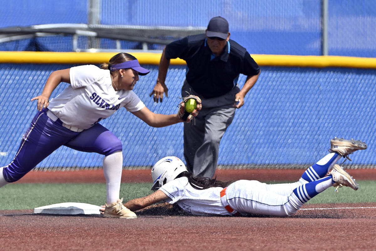 Bishop Gorman’s Allie Bernardo slides safely under the tag at third base against Silvera ...