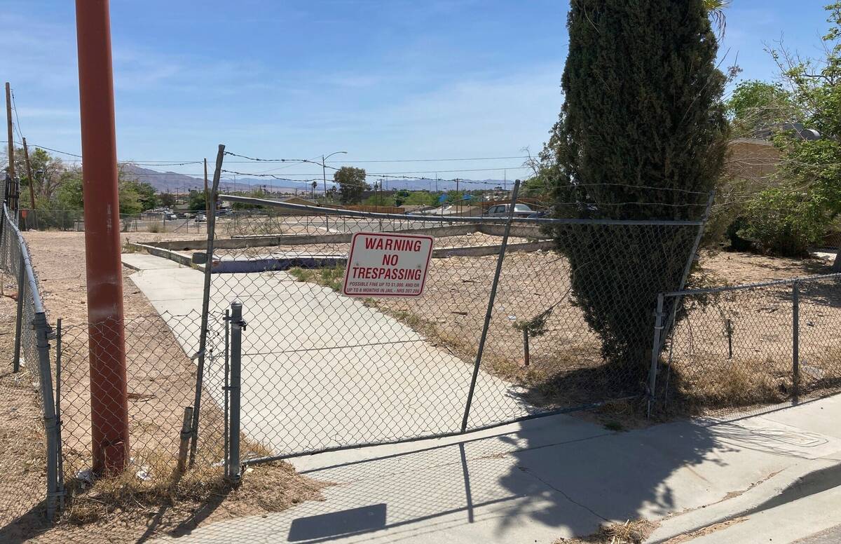 A fence lines an uneven foundation where a home once stood in the Windsor Park neighborhood of ...