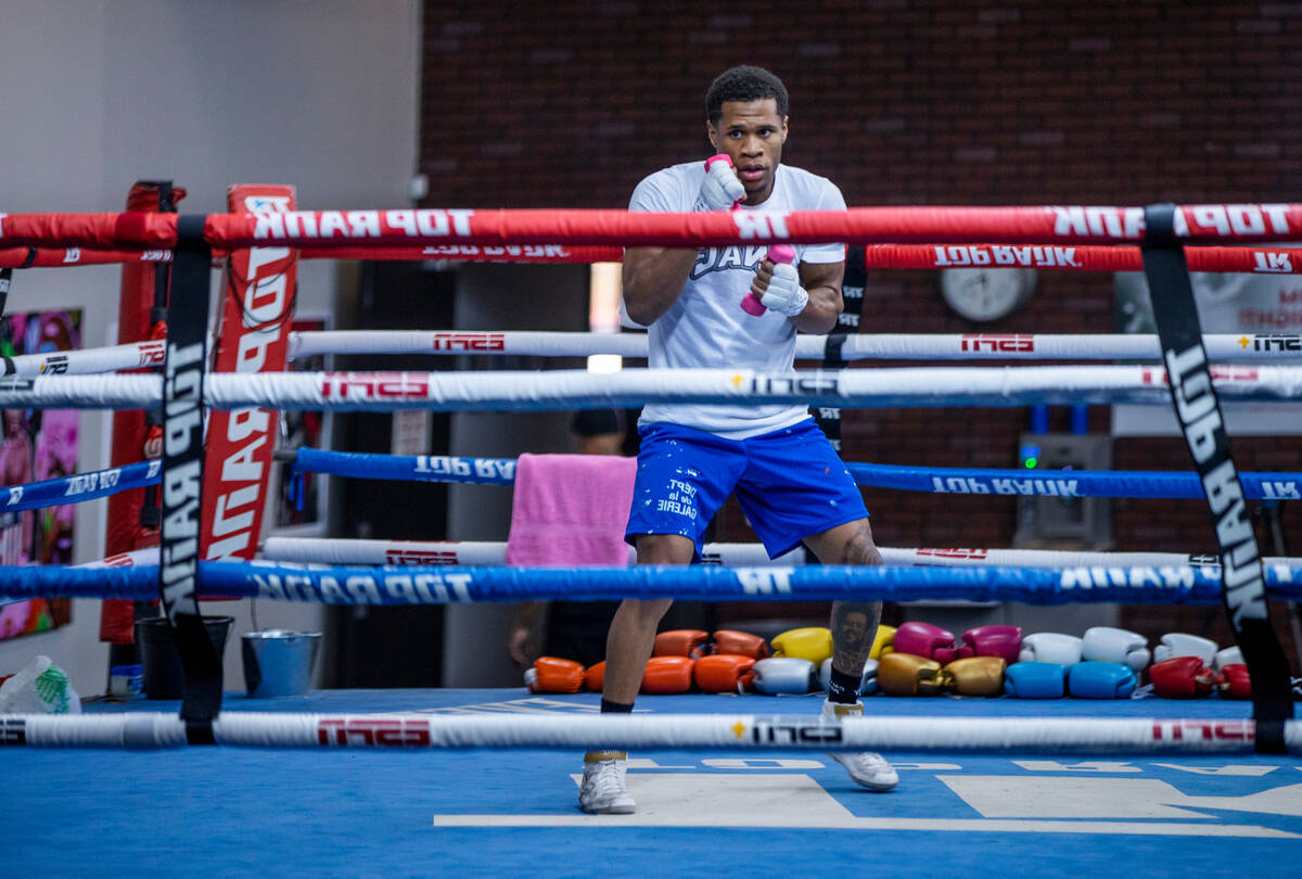 WBC lightweight boxer Devin Haney shadow boxes with hand weights in the ring during a workout s ...