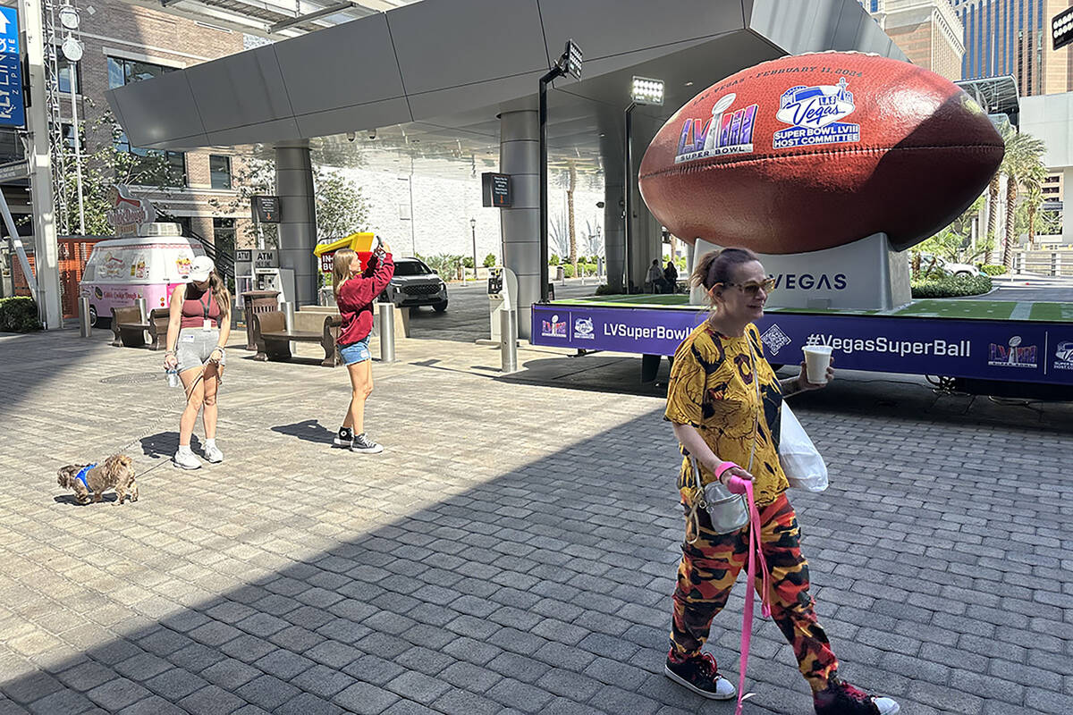 Pedestrians walk by the Vegas Super Ball Friday, May 19, 2023 at the Linq Promenade. (Mick Aker ...