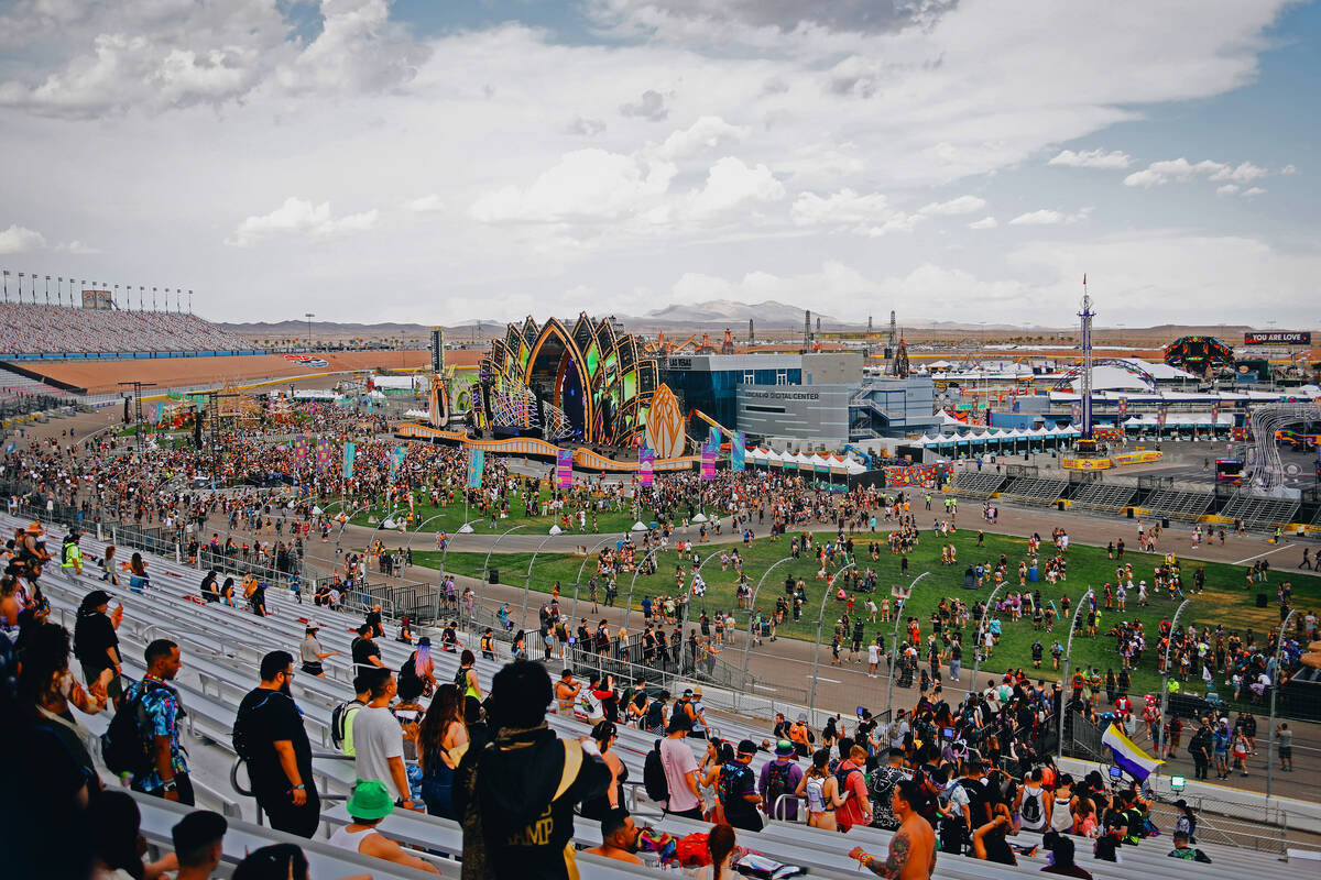Attendees walk throughout the festival grounds during the first day of Electric Daisy Carnival ...