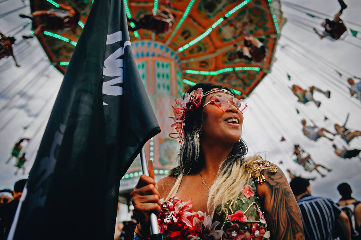 Valerie Bartolome laughs with her friends (out of frame) during the first day of Electric Daisy ...