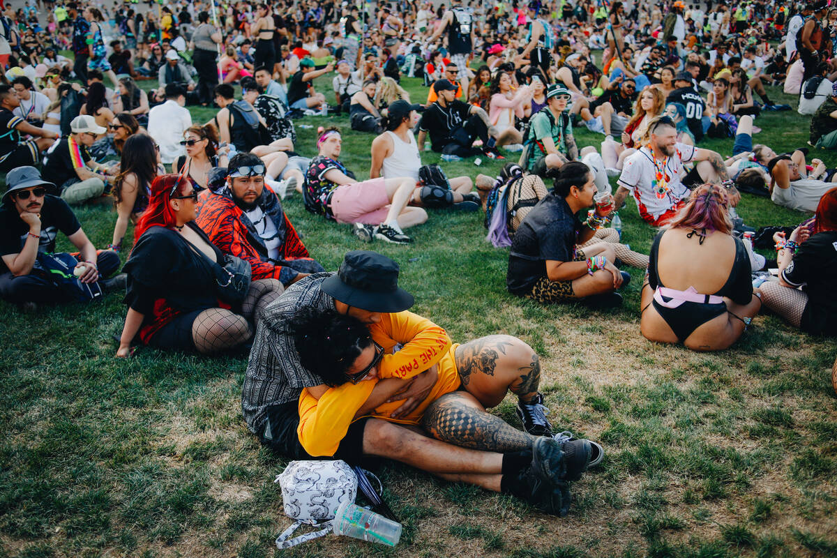Festival attendees sprawl out on the grass during the first day of Electric Daisy Carnival at L ...