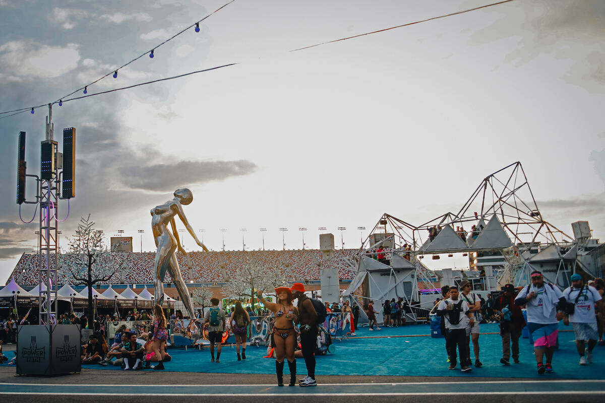 Festival attendees take selfies and walk throughout the festival grounds during the first day o ...