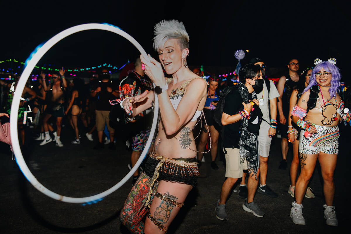 Billie Peterson, left, dances with a hula hoop during the first day of Electric Daisy Carnival ...