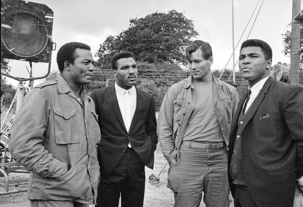 FILE - Muhammad Ali visits the film set of "The Dirty Dozen" with, from left, Jim Brown, Rahama ...