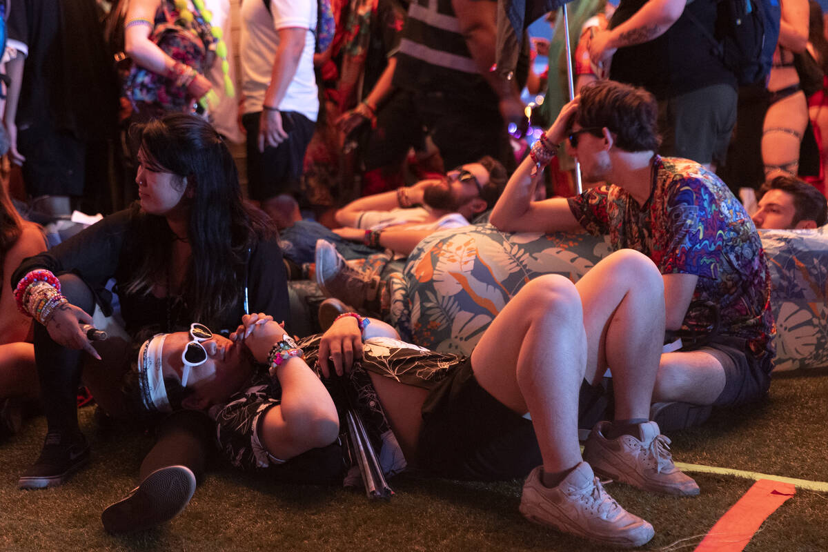 Attendees rest during the second day of electronic dance music festival Electric Daisy Carnival ...