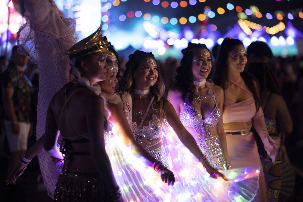 Attendees pose for photos during the second day of electronic dance music festival Electric Dai ...