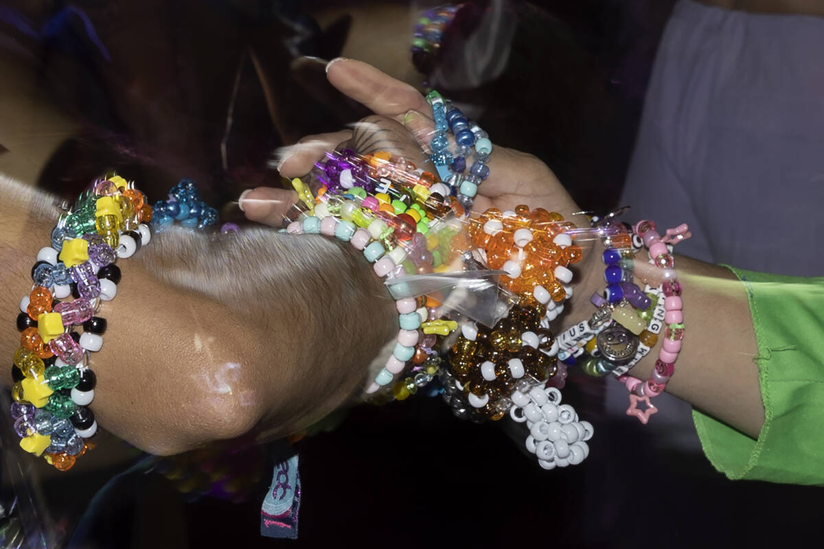 Attendees exchange bracelets as a sign of PLUR culture during the second day of electronic danc ...