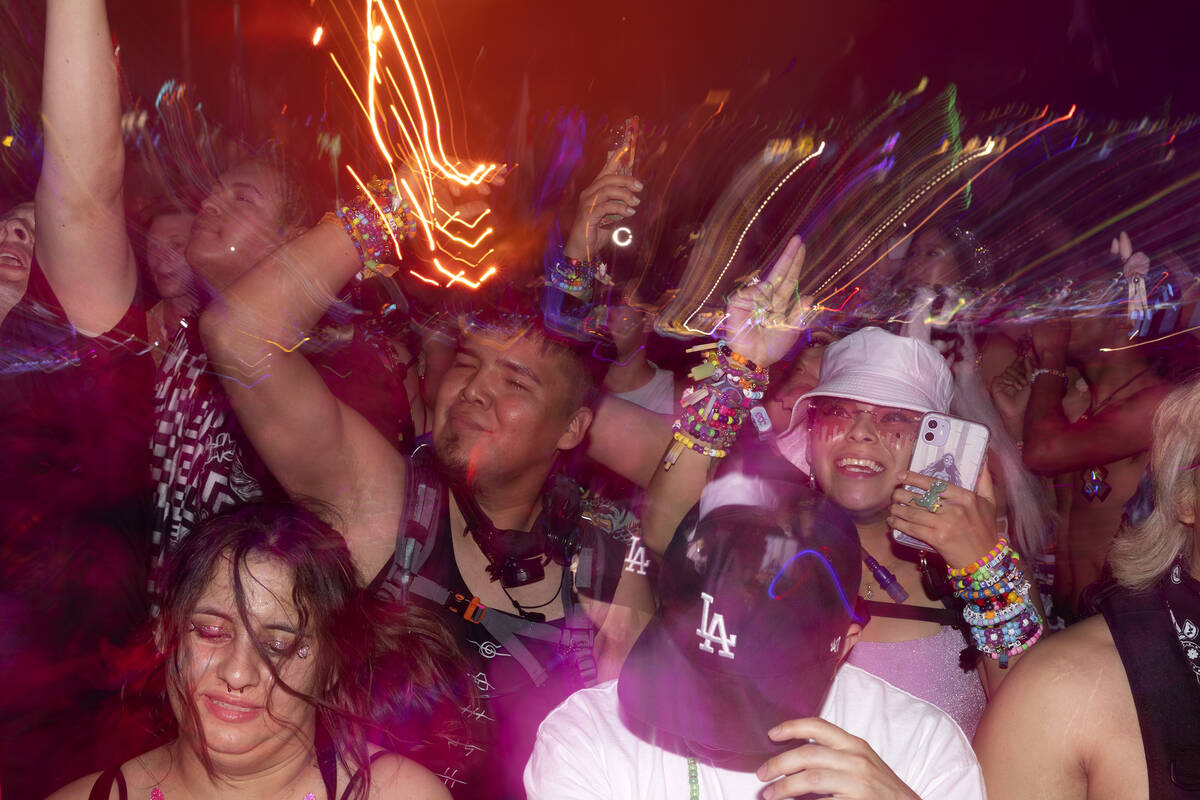 Ravers pump their fists during the second day of electronic dance music festival Electric Daisy ...