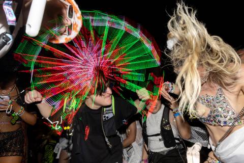 Attendees rock out to electronic dance music during the second day of Electric Daisy Carnival o ...