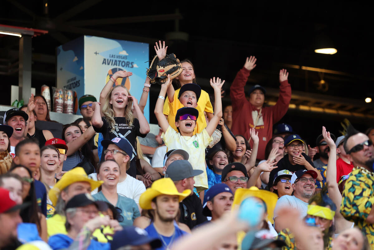 Savannah Bananas fans cheer during the Banana Ball World Tour at the Las Vegas Ballpark Friday, ...