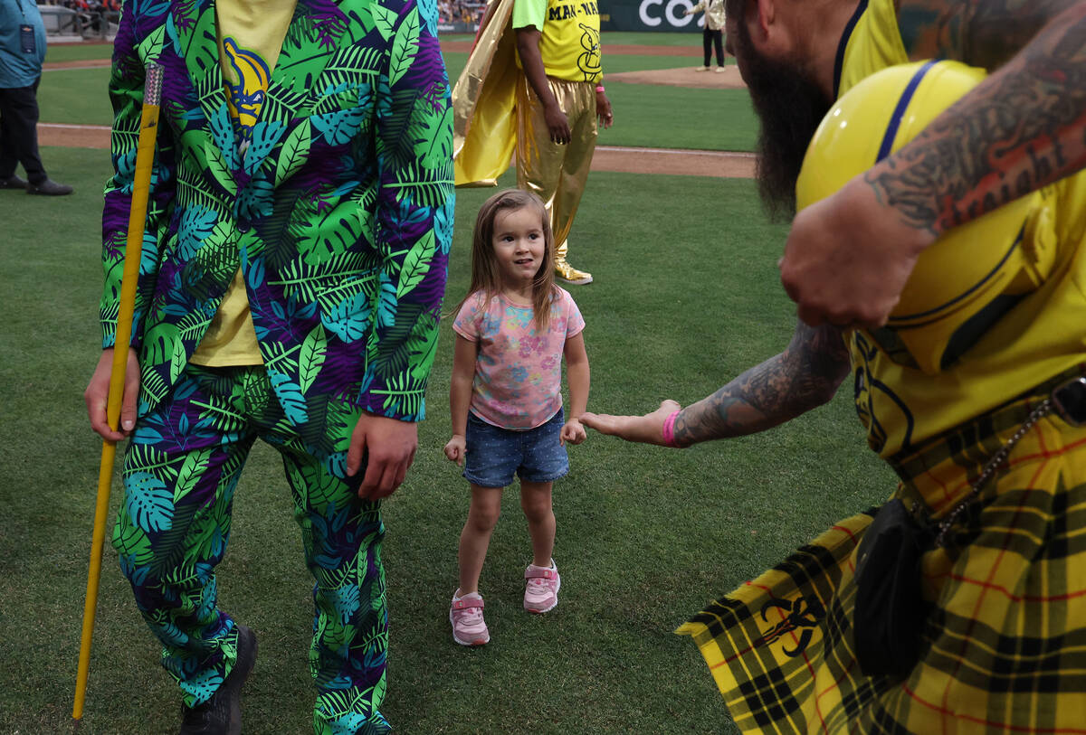 Savannah Bananas fan Noelle Casebolt, 3, of Overton, looks to slap hands after playing a game o ...