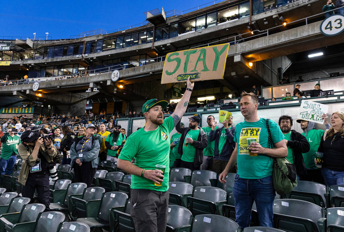 The Oakland A's fan Chris Scott protests at the Oakland Coliseum during a baseball game between ...