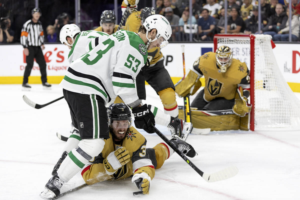 Golden Knights defenseman Brayden McNabb (3) battles for the puck on the ice with Dallas Stars ...