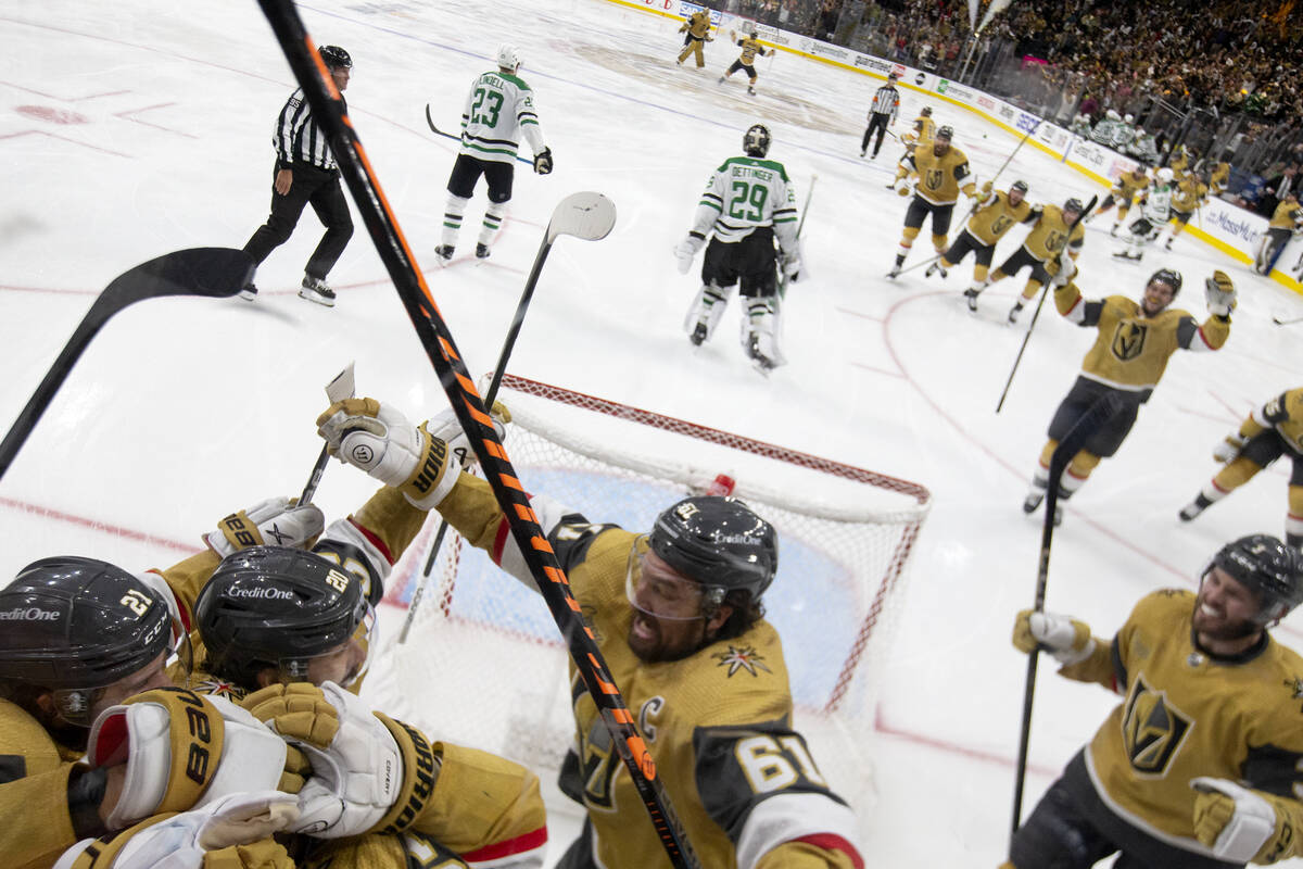 The Golden Knights skate to dog-pile center Chandler Stephenson, second from left, after he sco ...