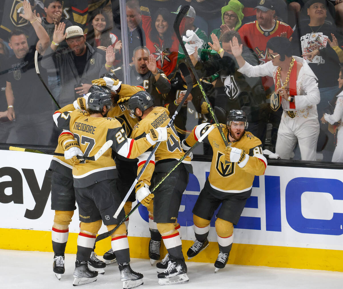 Golden Knights right wing Jonathan Marchessault (81), right, celebrates his teammates after sco ...
