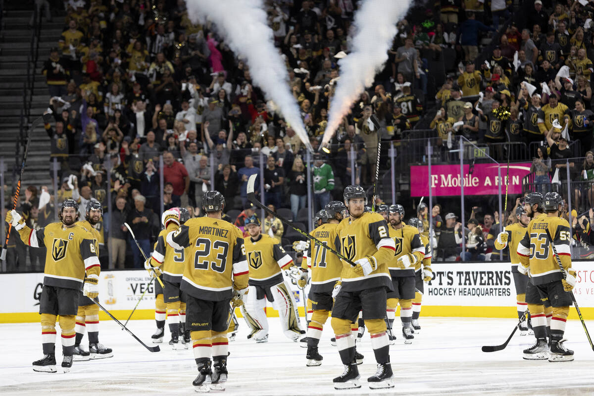 The Golden Knights celebrate after winning Game 2 of the NHL hockey Stanley Cup Western Confere ...