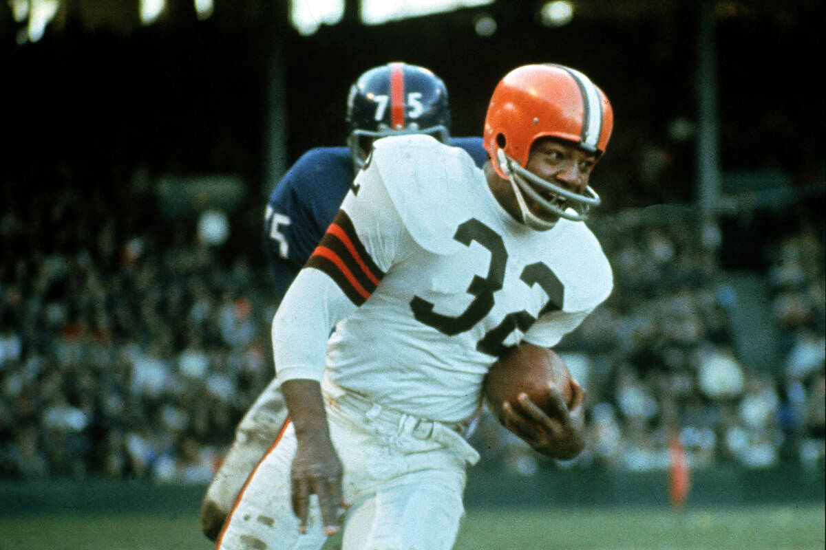 FILE - Jimmy Brown (32), running back for the Cleveland Browns, is shown in action against the ...