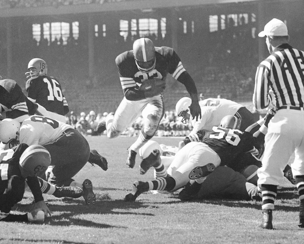 FILE - Fullback Jim Brown of the Cleveland Browns hurdles through a big hole for a 3-yard touch ...